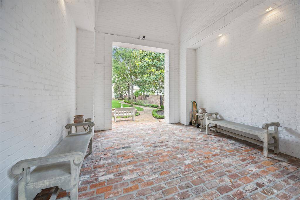 A lovely entrance leads into the courtyard, complete with bench seating.