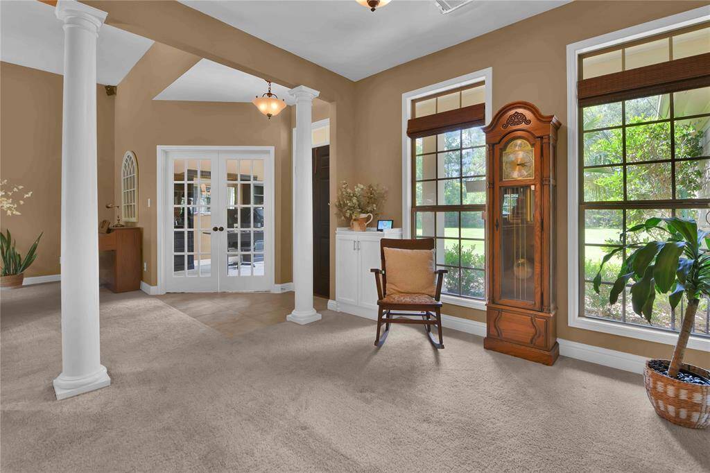 View to the front door from the Formal living area.  Notice the floor to ceiling windows that bring in tons of natural light
