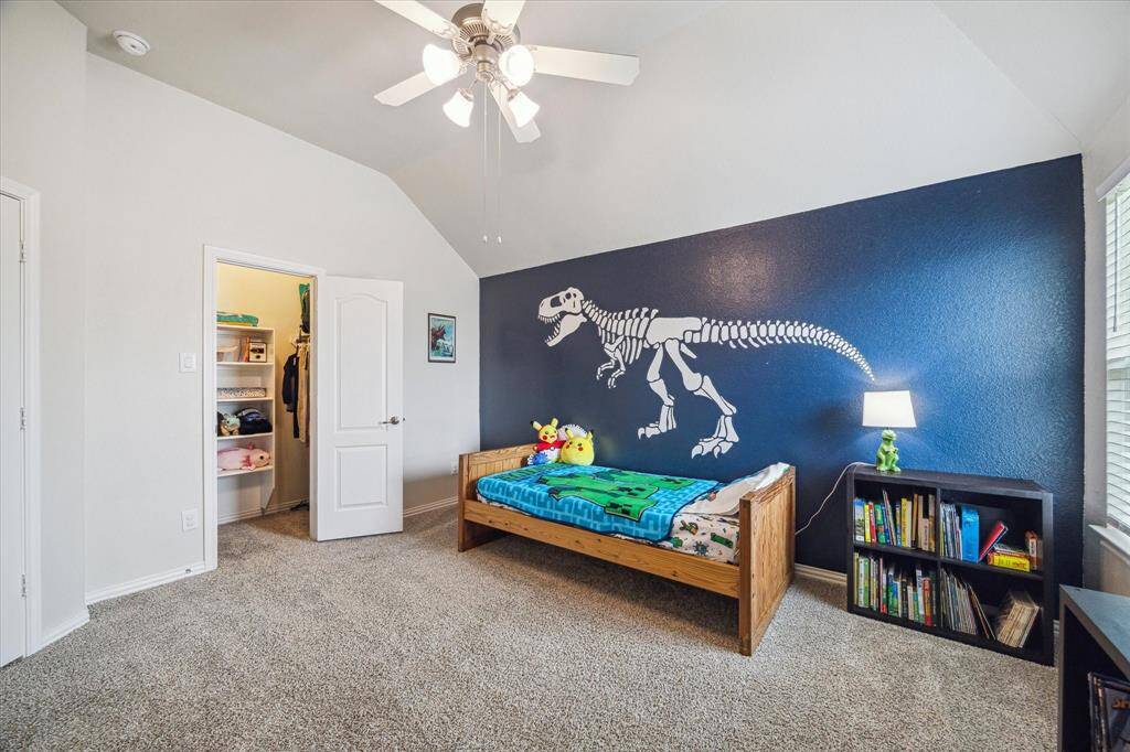 The second upstairs bedroom has a step in closet with wood shelves and connects to the third upstairs bedroom via a Jack & Jill bathroom.