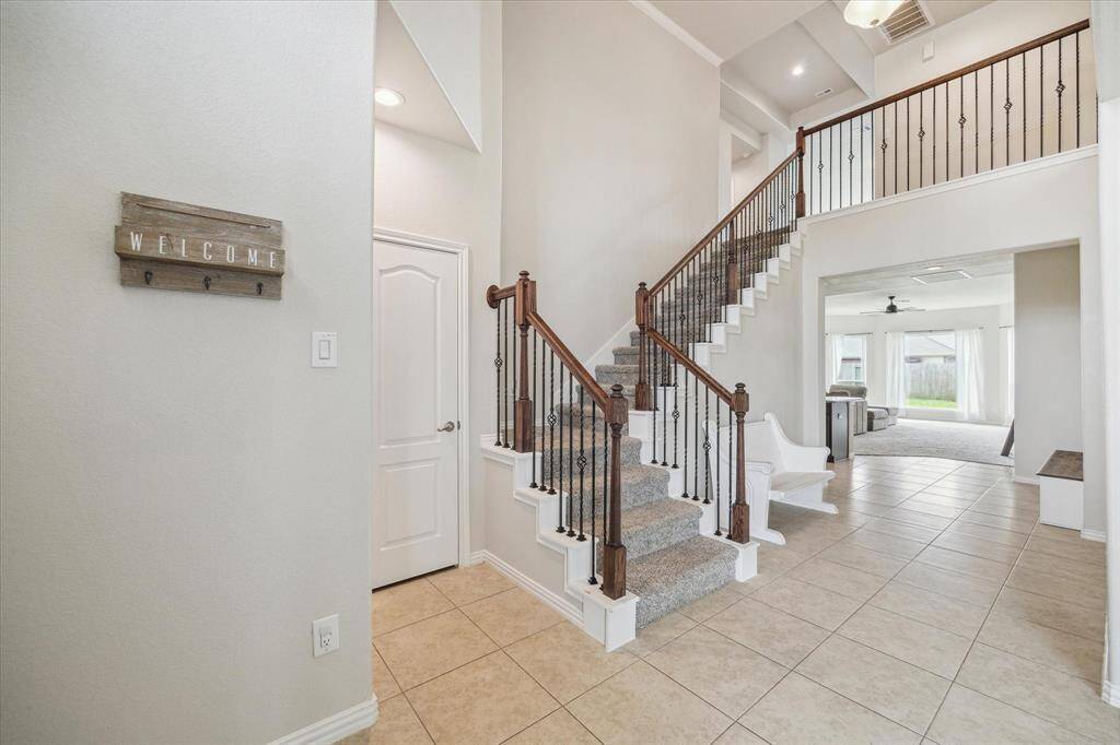 This amazing double height entryway and elegant stair with upgraded wrought iron spindles welcomes you and your guests!