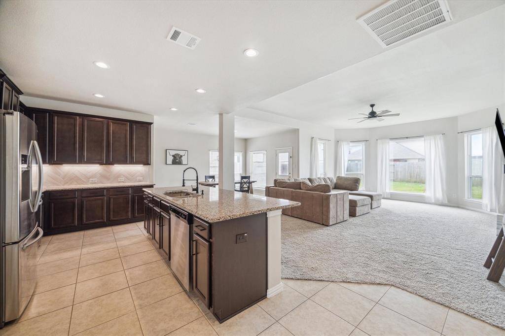 Your new kitchen features several upgrades including extra height overhead cabinets; upgraded granite countertops; and upgraded herringbone backsplash!