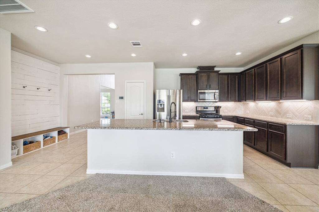 A look back from the living room toward the kitchen and entry.