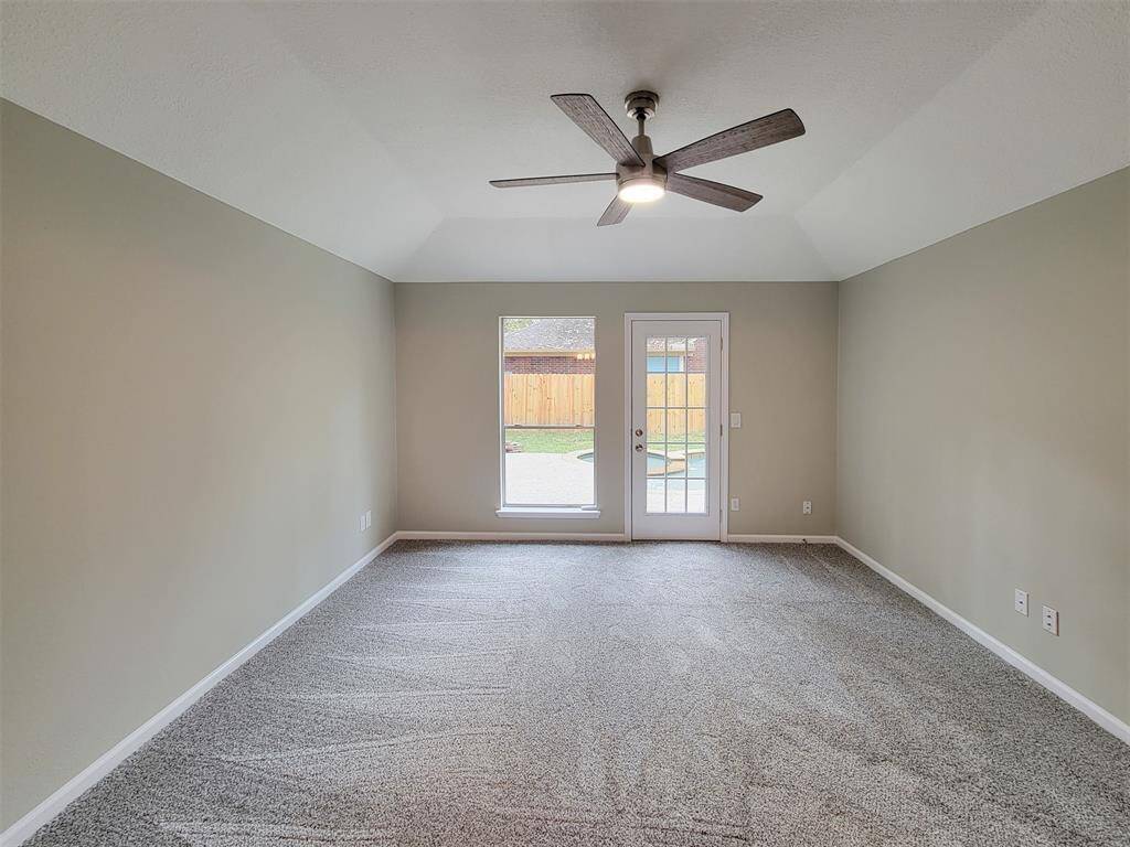 Primary suite also features a ceiling fan.