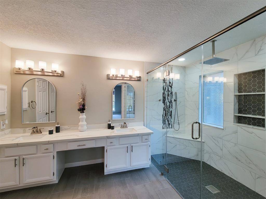 Primary bathroom with double sinks and spectacular walk-in shower.