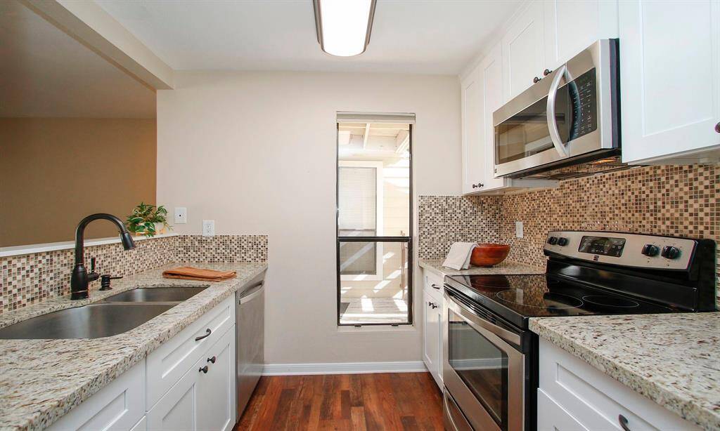 The updated Kitchen features granite counters, a tiled back splash and stainless steel appliances. Please note that the stainless steel refrigerator stays with the unit! Range/Dishwasher/Microwave/Refrigerator all replaced in mid-2018.