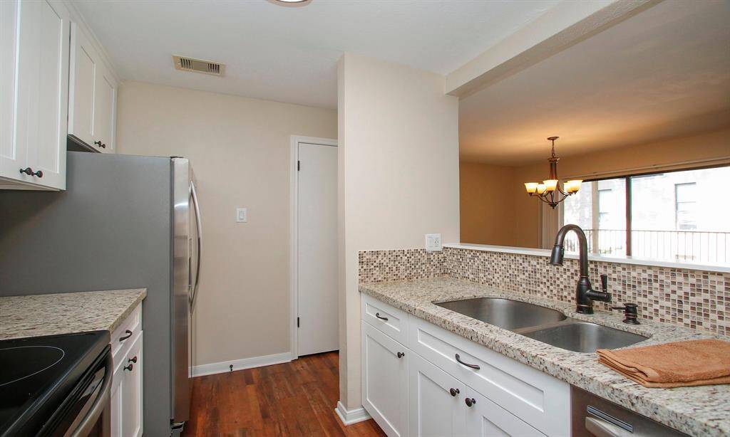 The Kitchen also offers an undermount sink, updated fixture, and modern white Shaker-style cabinetry.