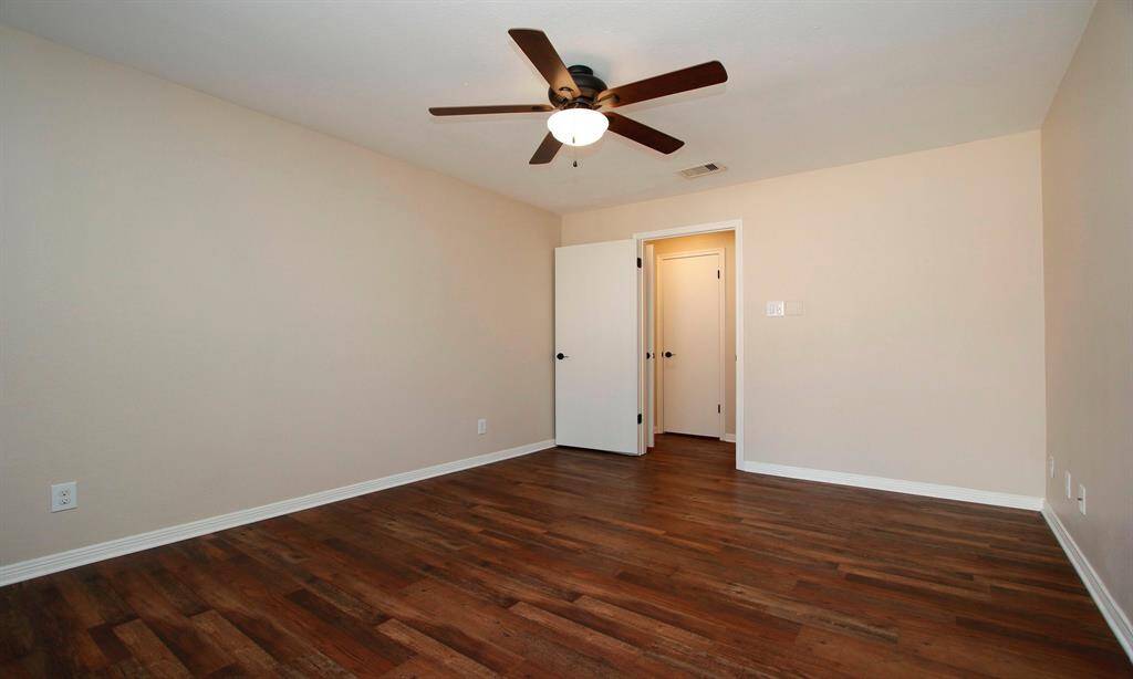 A look back out of the bedroom towards the hallway and walk-in closet.