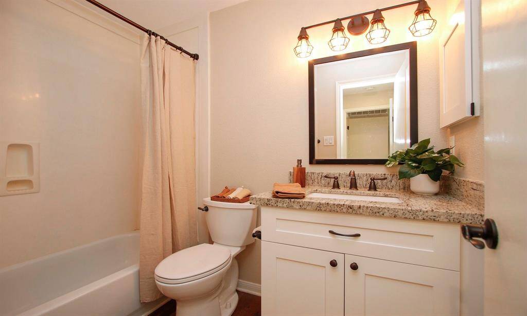 The full Bath offers an updated Shaker-style vanity with granite counters along with a combination shower/tub.