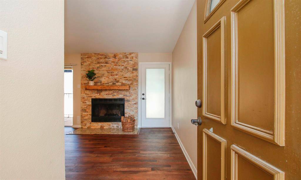 Neutral paint colors and warm LVP flooring run through the unit; HVAC components replaced in 2017. Note that there is a backdoor to the unit as well leading to a flight of stairs.