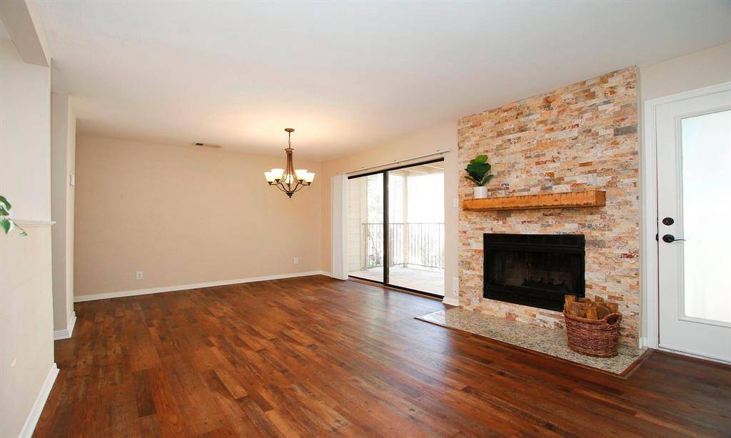 The living room is anchored by a handsomely remodeled stacked-stone (wood burning) fireplace!