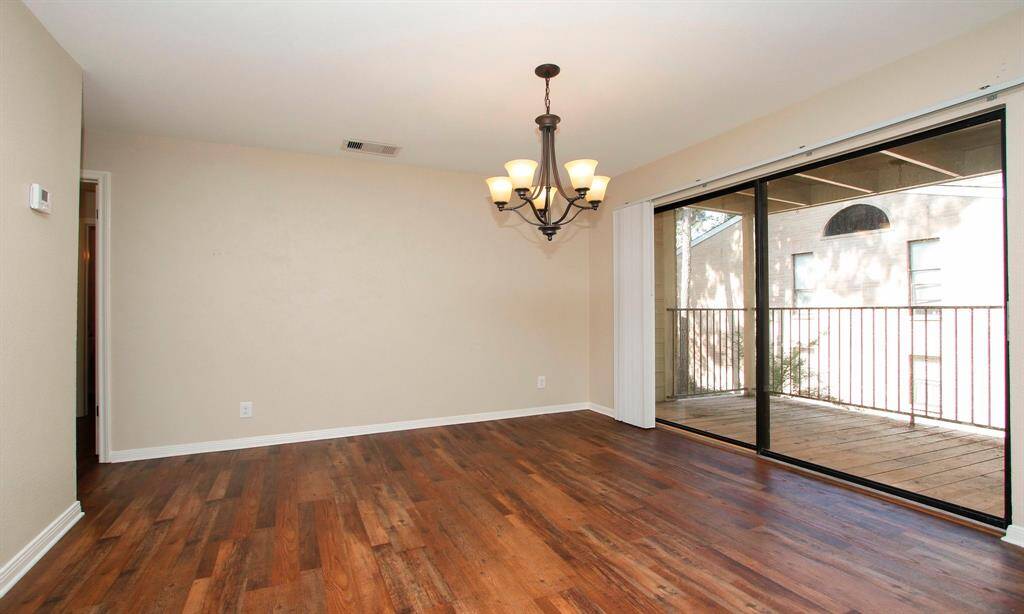 There is also a covered balcony (recently replanked) off of the combined living space looking down into a courtyard.