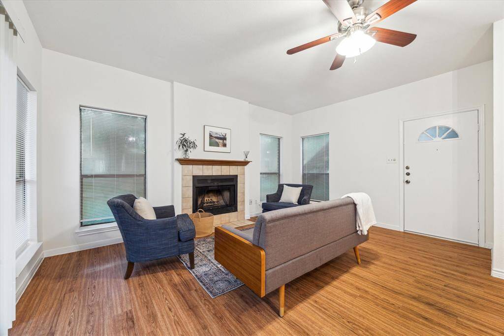 Four large windows (and the sliding glass door on the opposite wall) provide ample natural light in the living area.