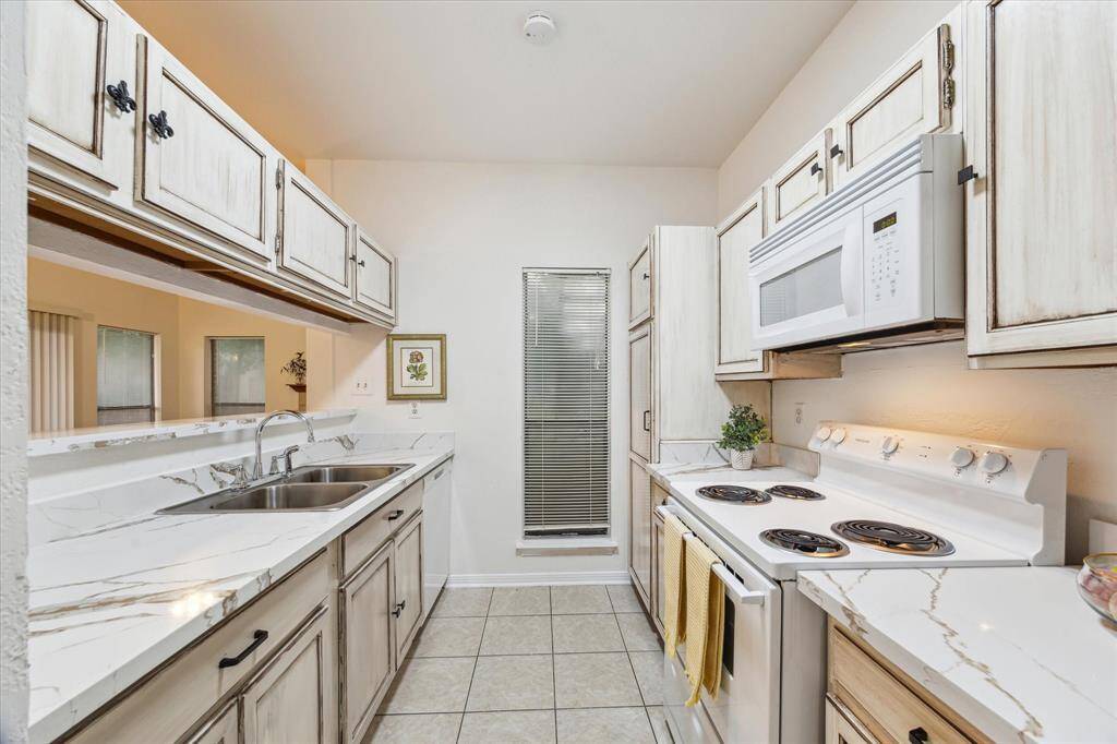 The kitchen features updated quartz countertops and modern appliances. Bright and functional space.