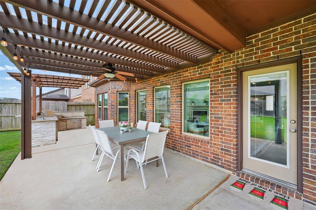 Covered outdoor kitchen with drop in grill, drawers, and refrigerator!