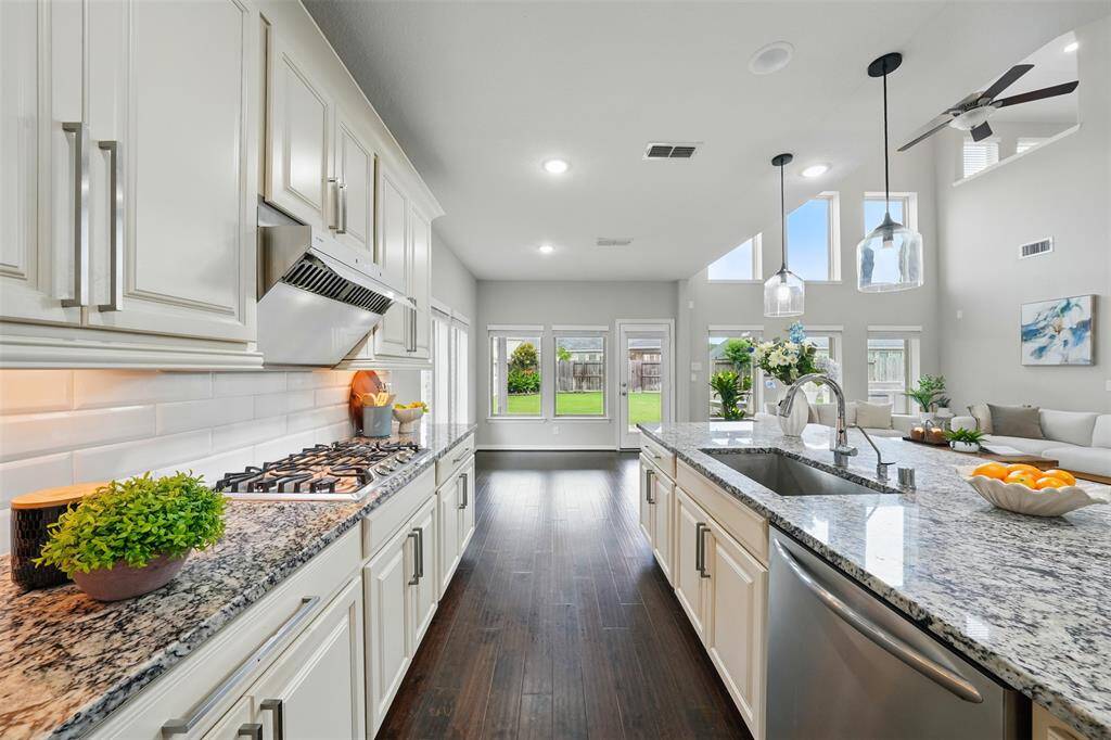 A bright and airy kitchen, bathed in natural light, showcasing a seamless flow between the indoors and outdoors.