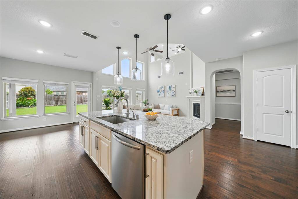 Open-concept elegance. Sunlight streams into this airy kitchen, highlighting the seamless flow to the great room
