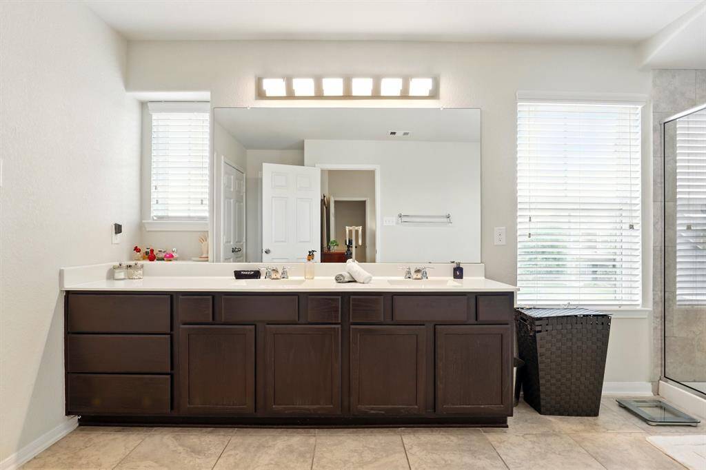 Spacious double vanity, and ample natural light in the master bathroom