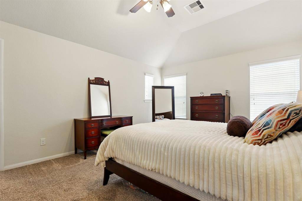 Flooded with natural light, the spacious primary bedroom offers a serene retreat.