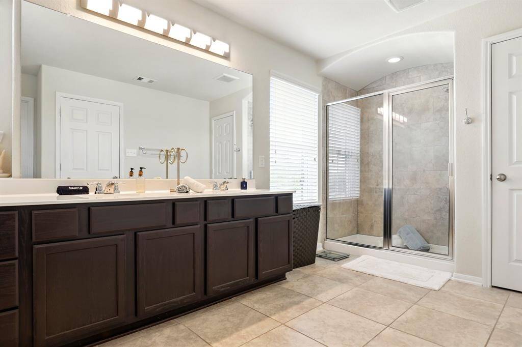 Spacious and bright master bathroom with oversized shower.
