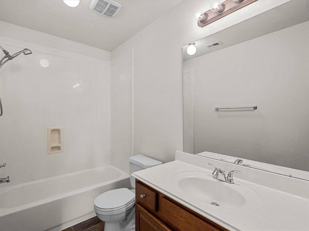 Guest bathroom is situated in the hallway and features a full bathroom to serve the two bedrooms, as well.