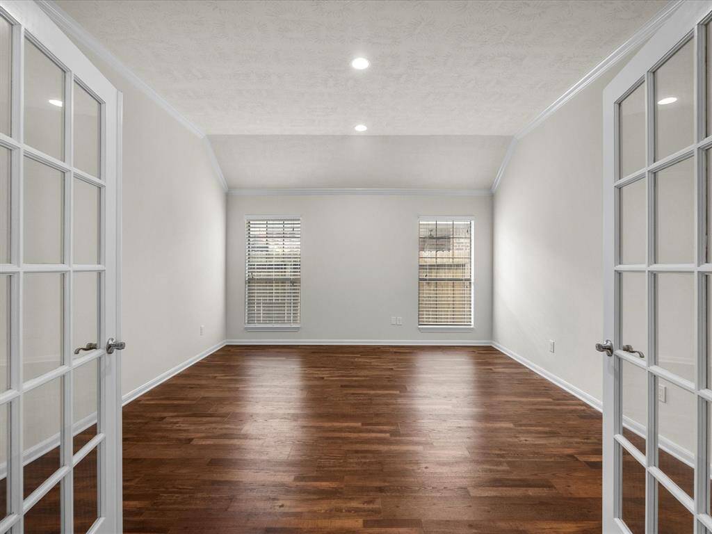 Inviting dining room or flexible-use room with double glass doors is centrally located for use as formal dining room or perfect for a large home office or library.  This room offers options limited only by your imagination!