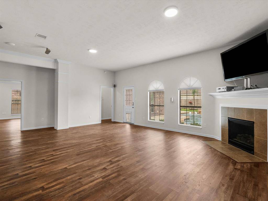 Living room with view of backyard pool and fireplace.  Large room with room to entertain and enjoy.