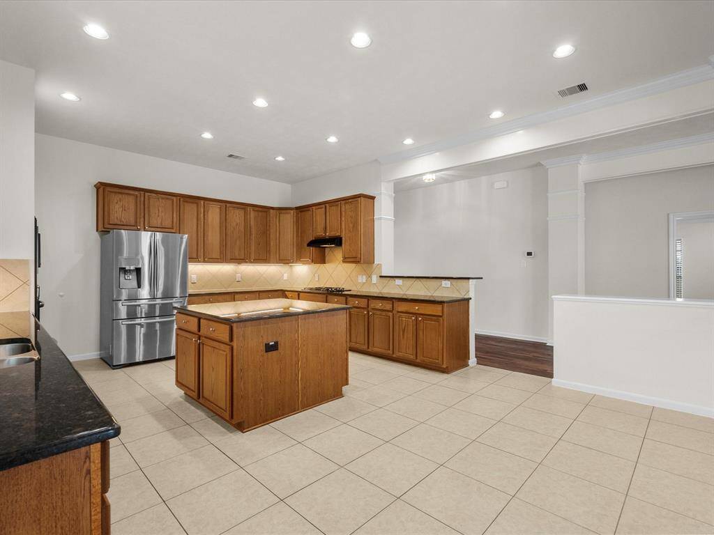 The heart of any home is the kitchen and this one will not disappoint!  Spacious kitchen with loads of cabinets and storage, black granite countertops and center island, gas cooktop and oven, under-cabinet lighting and more!