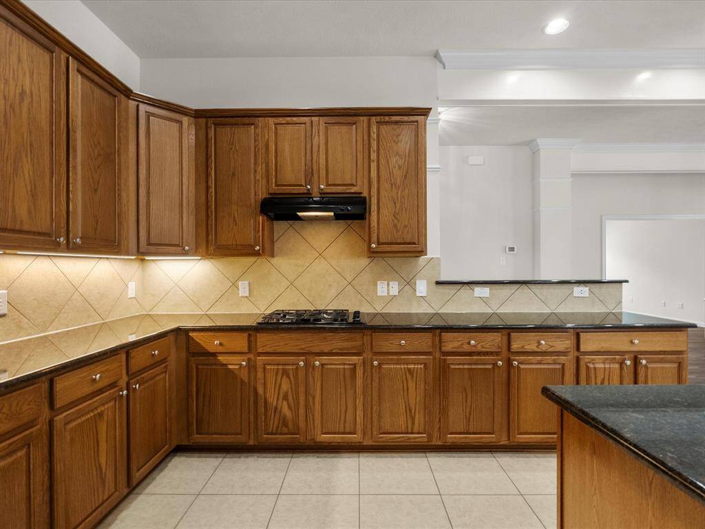 View of kitchen from the laundry room, hall beyond