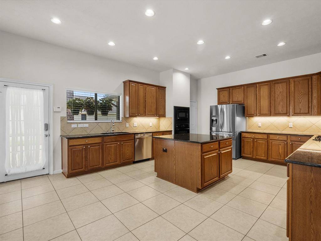 View of side door off of porte cochere, kitchen window and simply a lovely kitchen!