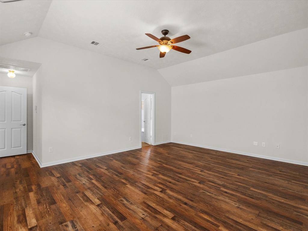 Primary bedroom, view toward en suite to the right and hall to the left.