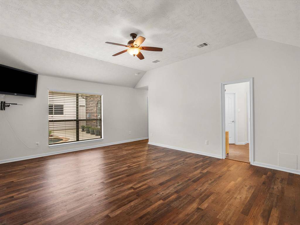 Primary bedroom, view toward the backyard oasis, and primary bathroom to the right.