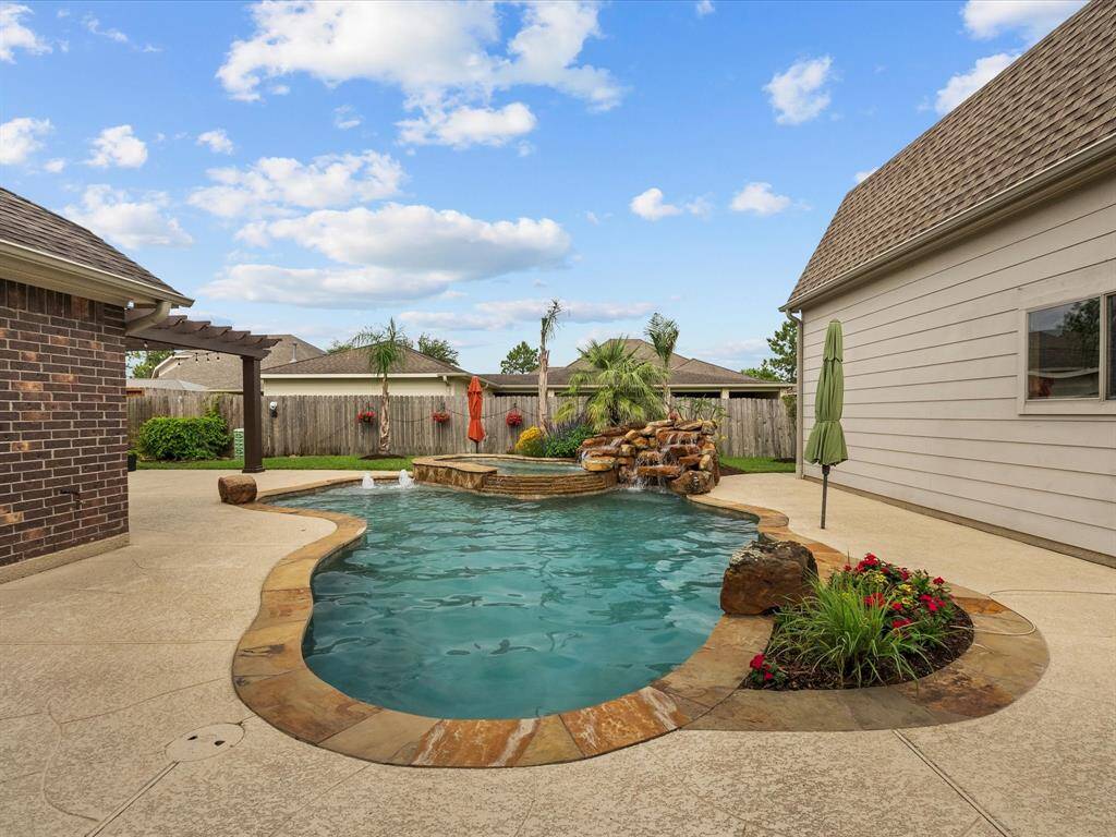 Your backyard paradise!  This oasis in your backyard will beacon to you all year long to come and enjoy!  The oversized spa, the double waterfall and bubbler in this heated swimming pool may become your favorite place to vacation daily!