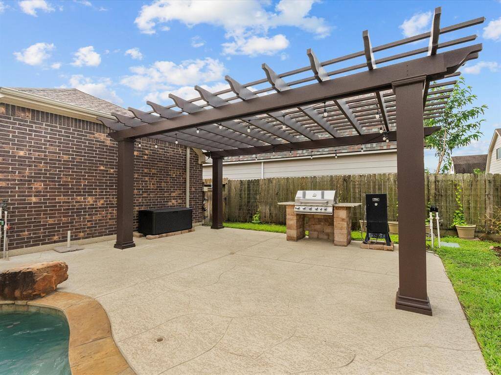 Plan your next outing to your backyard paradise! To sit and relax or to party till the sun goes down, this outdoor kitchen features a Jenn-Air gas grill and a 22' x 14' windstorm-rated fiberglass pergola.  Add family or friends, a little BBQ and music and your summer couldn't be more fun!
