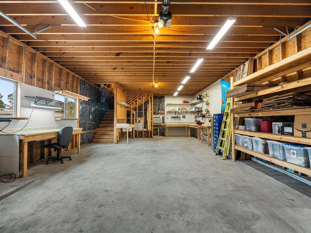 A lot of something to make your heart go pitter-pat!  This garage is everything!  3.5 car garage, built-in work space and shelving; stub outs for water and sewer for additional bathroom, if you desire; 10' stud construction with 9' garage door.  Upstairs encompasses the full expanse of the garage!  Currently unfinished, the buildout is up to you and the HOA!  ENJOY! Boat parking and ladder-handling are all within your capabiities now!