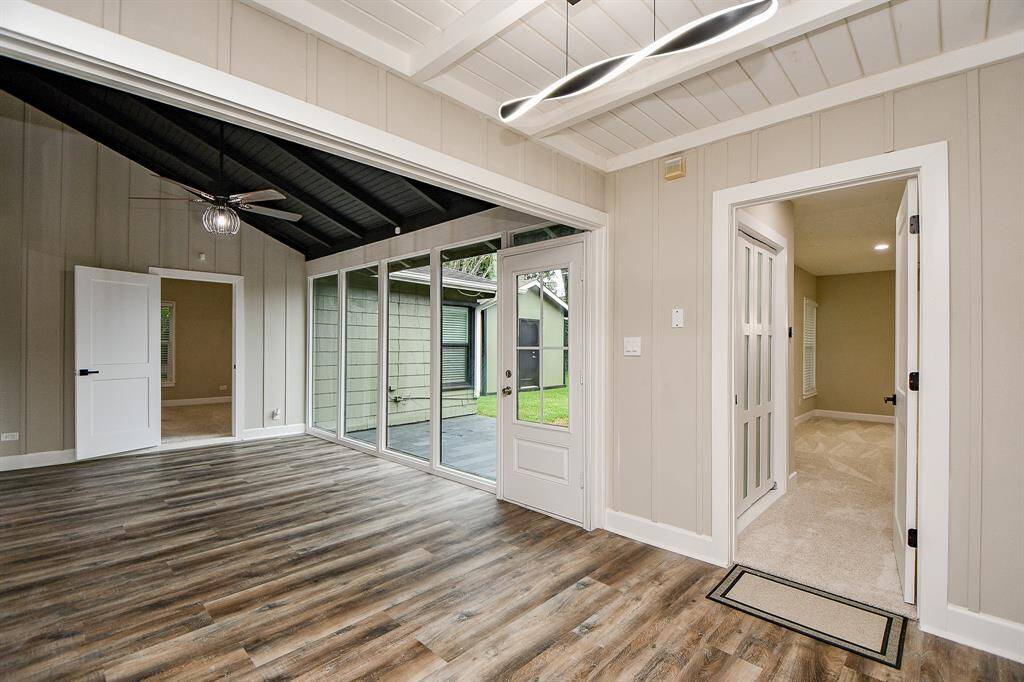 This gameroom/flexroom extension of family room. Features a bright and airy space with large windows and sliding glass doors for abundant natural light. Opens to a view of outdoor patio.