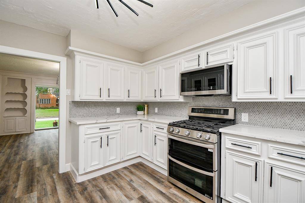 Kitchen Pic #2 The space is bright with ample counter space and flows into a dining room with built-in shelves and large windows overlooking front yard.