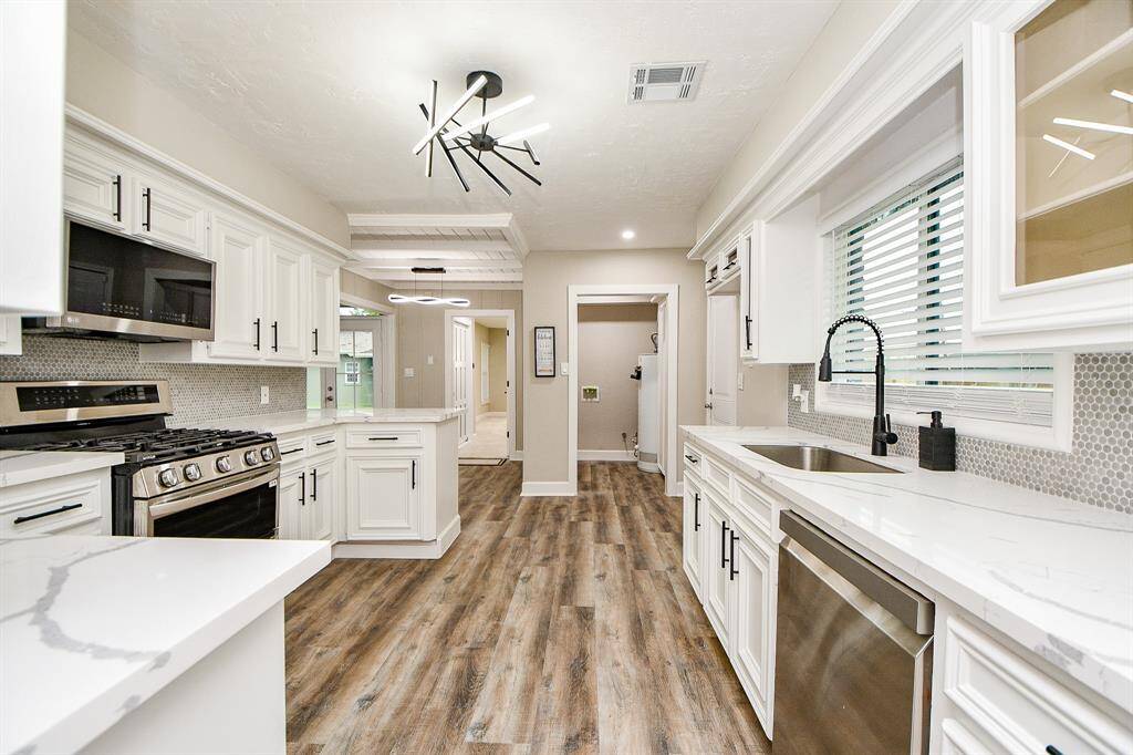 Check out the contemporary light entering into kitchen from dining room. Very functional layout.