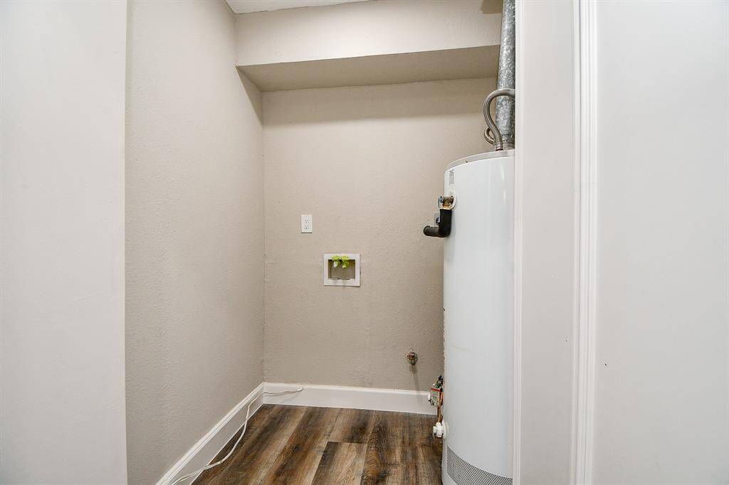 Indoor utility area with hook-ups for full size stackable washer/dryer./additional storage with a water heater.