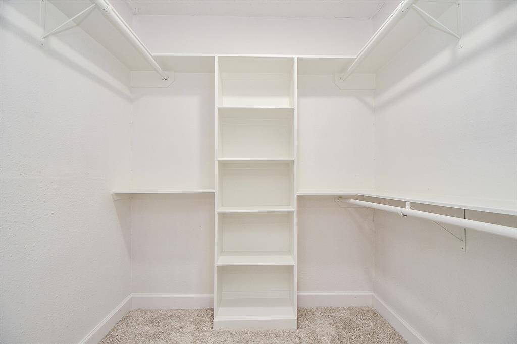 Primary bedroom spacious walk-in closet offering ample storage space.
