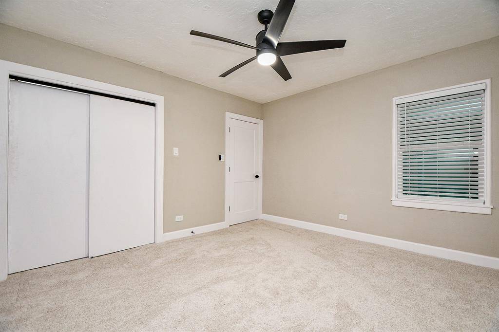 Secondary bedroom-1  features neutral walls and plush carpet, offering a clean and modern look.