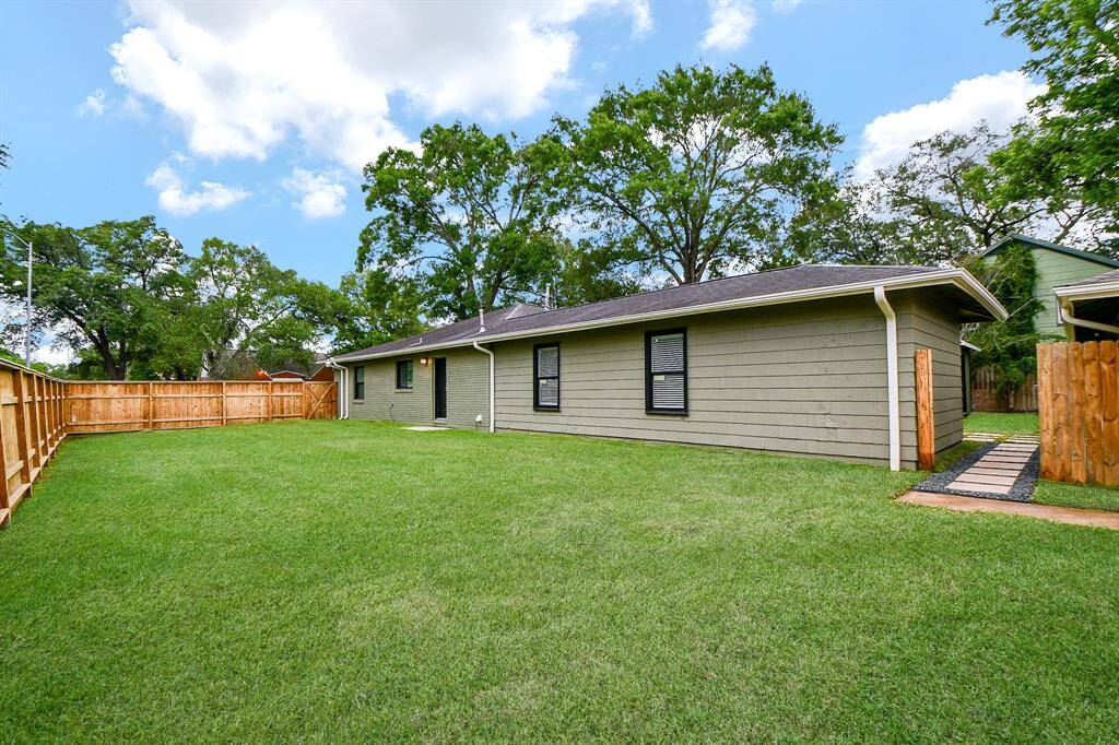 This generous fenced sideyard offers additional flex area for outdoor activities.