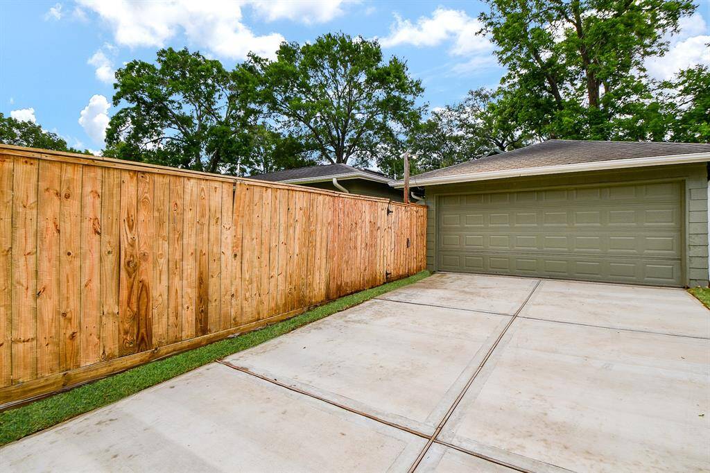 New concrete driveway leading to a two-car garage.