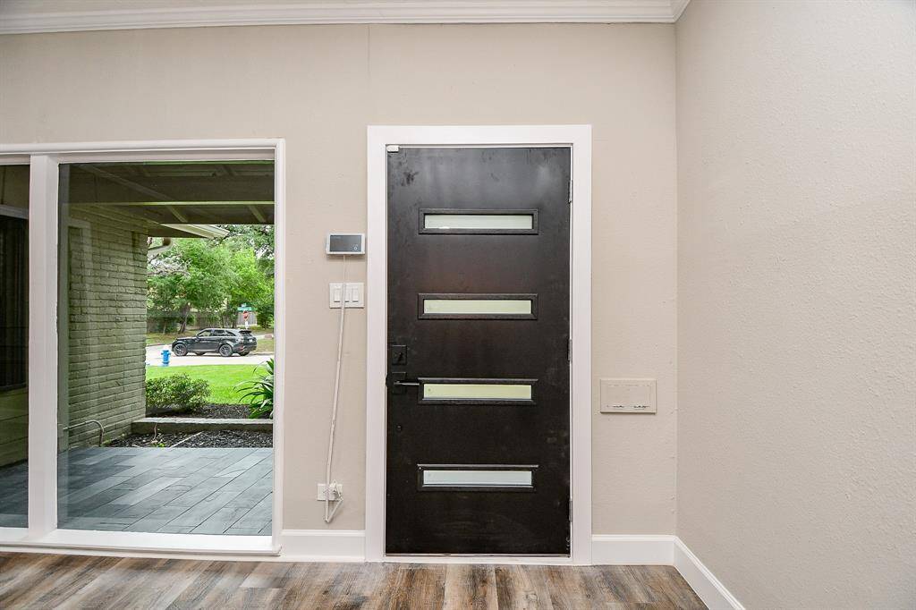 Modern door that showcases large windows creating a welcoming atmosphere.