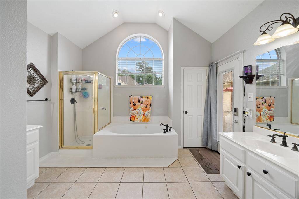 oversized primary bathroom with two closets