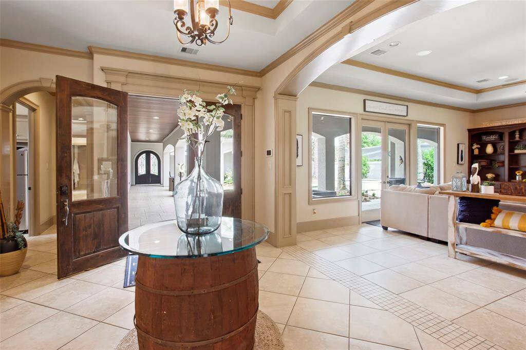 Nice and open entry has a wall of windows looking back to the atrium/pool area.