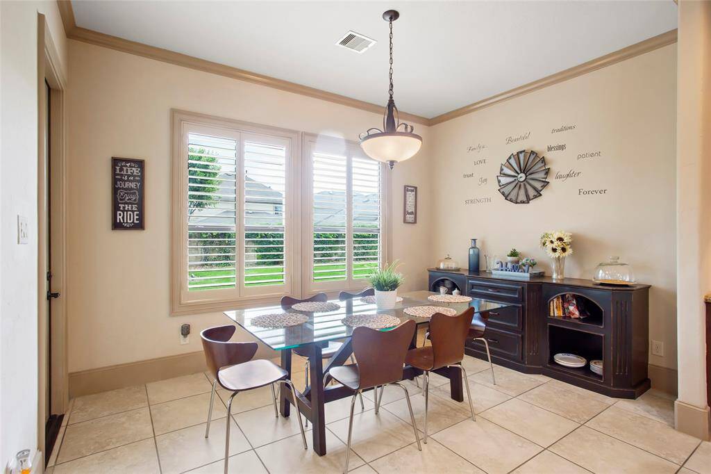 Breakfast area overlooks the backyard with plantation shutters.