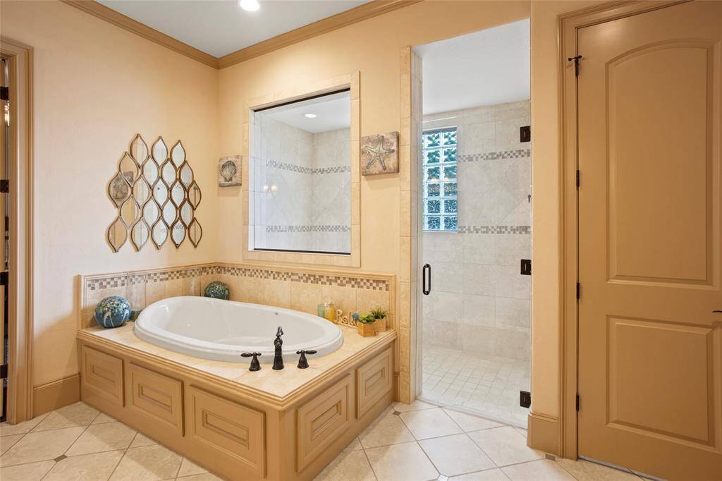 Jetted soaking tub with oversized walk in shower measuring 9'8x 4'5 with double shower heads.
