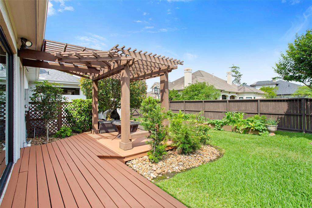 Lovely side yard with pergola and metal raised bed organic garden.