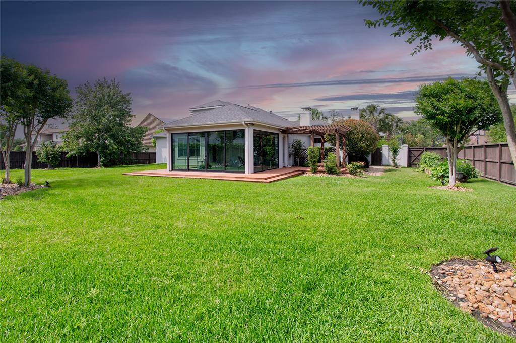 Large fenced backyard, full lot measures .65 acres. Cross fenced on left side leading back to the atrium/pool. Right side (not pictured) has double gate and concrete pad for private storage. 13 zone wireless Rachio SMART sprinkler system front and back along with full home gutters tied to french drainage.