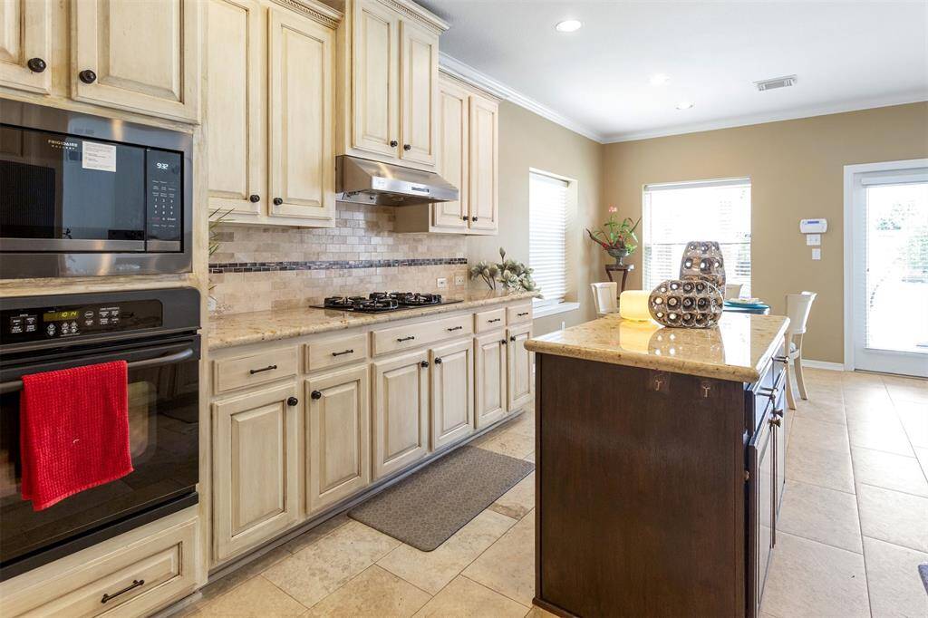 Experience elegance with hand-polished lacquer cabinets and a stylish two-tone kitchen island.